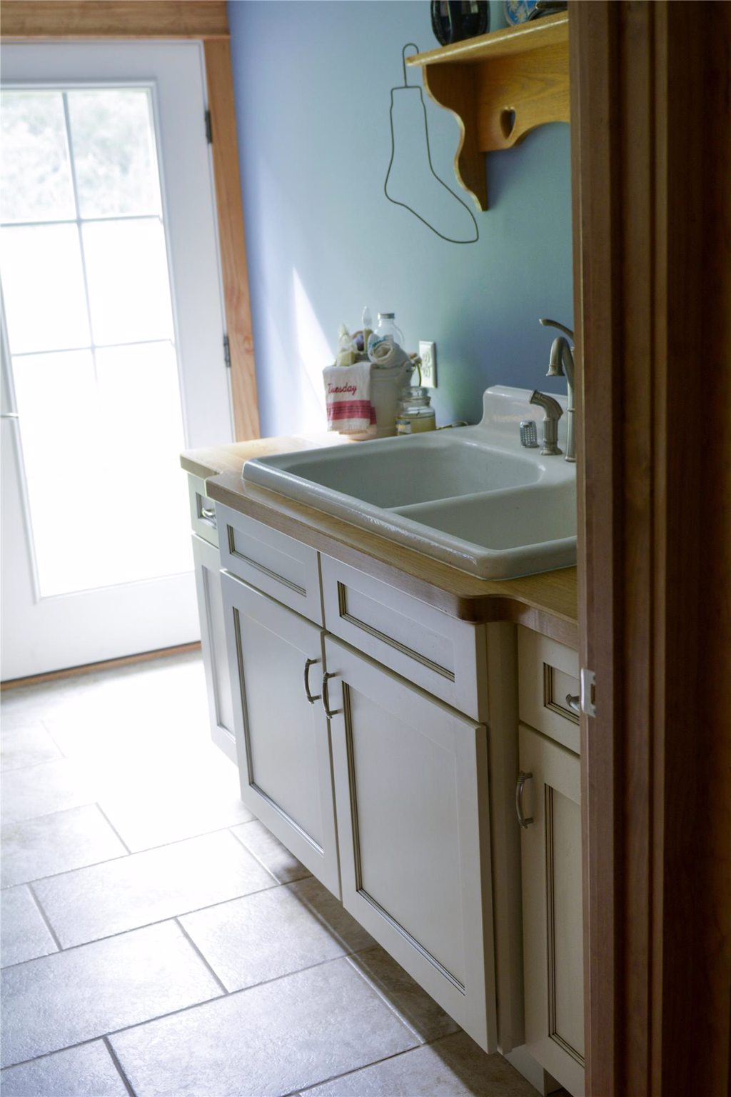 Laundry Room Remodel with Sink and Storage Cabinets on a Tile Floor