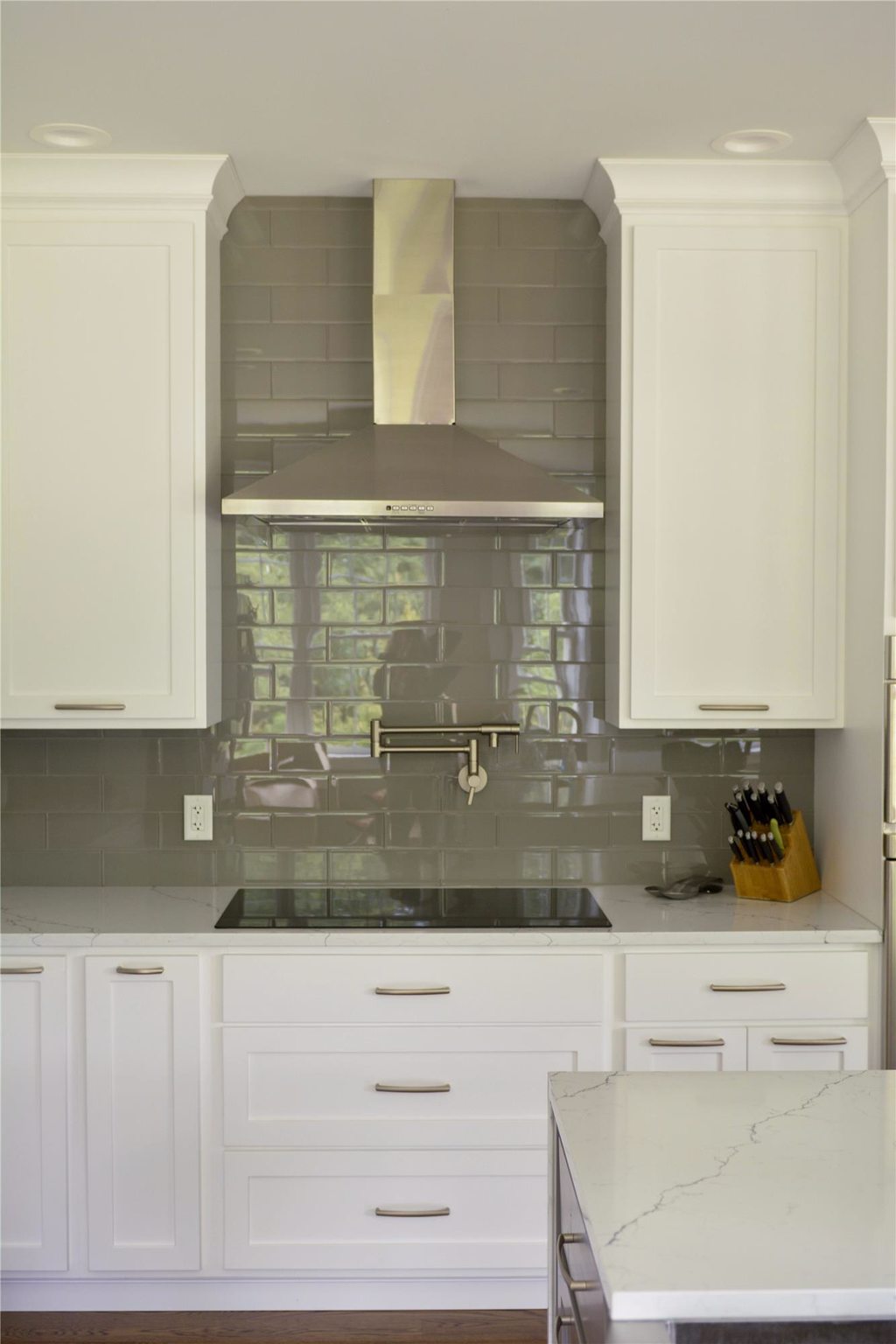 Remodeled Kitchen with Backsplash, Outlets, and Vent Hoods